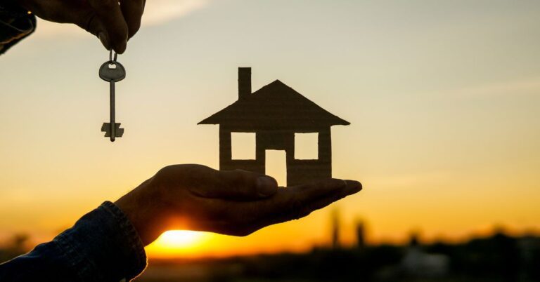 Ръце, Които Държат Форма На Къща и Ключ Пред Залез Слънце и Хоризонта.